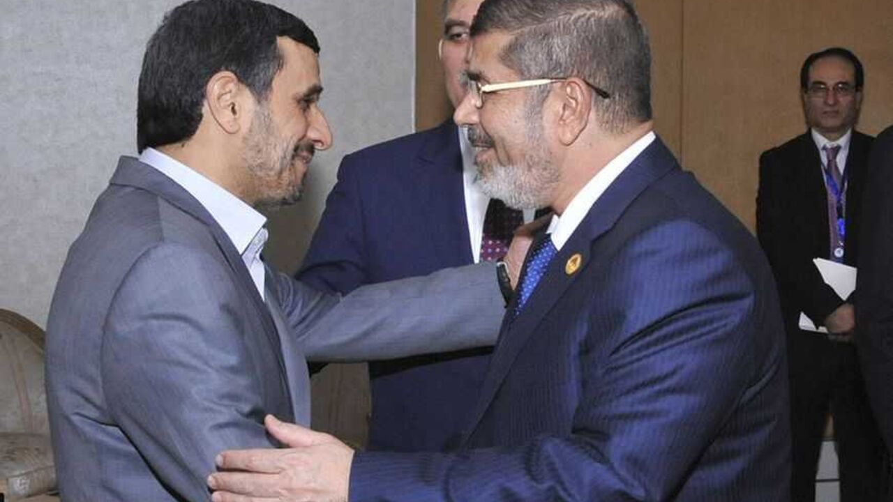 Egyptian President Mohamed Mursi greets Iran's President Mahmoud Ahmadinejad as Turkish President Abdullah Gul look on before meeting at the Organisation of Islamic Cooperation (OIC) summit in Cairo Egyptian President Mohamed Mursi (R) greets Iran's President Mahmoud Ahmadinejad as Turkish President Abdullah Gul look on before meeting at the Organisation of Islamic Cooperation (OIC) summit in Cairo February 6, 2013. Leaders of Islamic nations called for a negotiated end to Syria's civil war at a summit in Cairo that began on Wednesday, thrusting Egypt's new Islamist president to centre stage amid turbulence at home. REUTERS/Egyptian Presidency/Handout (EGYPT - Tags: POLITICS) ATTENTION EDITORS - THIS I