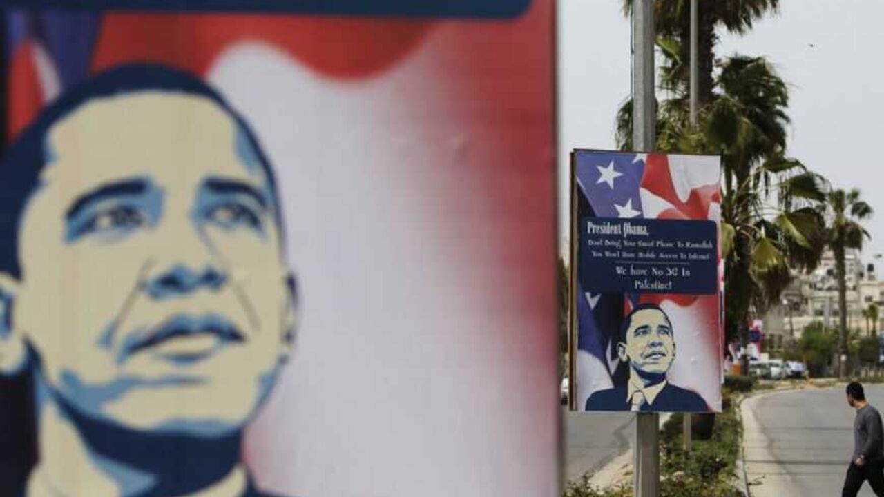 A Palestinian man walks near placards designed by an activist depicting U.S. President Obama, ahead of his visit to the region, in Ramallah A Palestinian man walks near placards designed by an activist depicting U.S. President Barack Obama, ahead of his visit to the region, in the West Bank city of Ramallah March 12, 2013. The White House has yet to officially announce the dates for the trip, but Israeli news media have reported that Obama will arrive in the region on March 20. REUTERS/Ammar Awad (WEST BANK - Tags: POLITICS) - RTR3EVUU