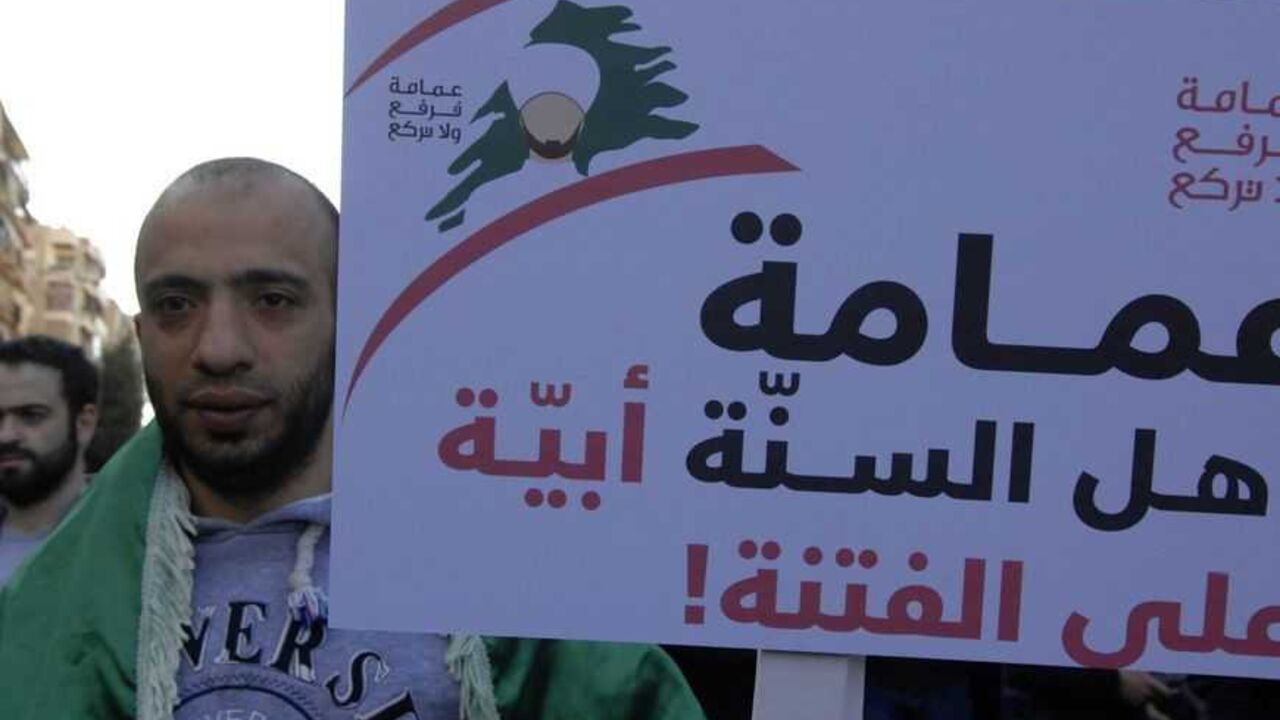 A Sunni Muslim protester carries a banner as he takes part in a protest in the majority Sunni Beirut district of Tariq al-Jadideh against the attacks on Sunni Muslim scholars A Sunni Muslim protester carries a banner as he takes part in a protest in the majority Sunni Beirut district of Tariq al-Jadideh against the attacks on Sunni Muslim scholars, March 18, 2013. Four Sunni Muslim scholars were beaten up in two separate attacks in Beirut on Sunday night, testing a fragile peace between the sects and factions that fought Lebanon's 15-year civil war. The sign reads 'The turban of the Sunni Clerics, is superior to strife'. REUTERS/Hussam Shebaro (LEBANON - Tags: POLITICS CIVIL U