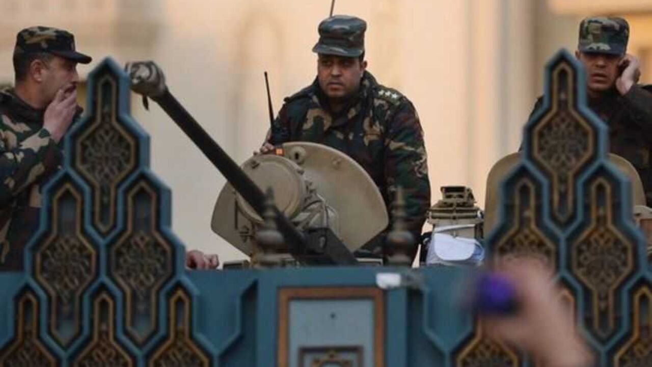 EGYPT-POLITICS-UNREST Egyptian presidential guards stand on a tank behing the presidential palace's gate as protesters gather in front of it in a show of opposition to Morsi and his Muslim Brotherhood on February 1, 2013 in Cairo. Egyptian security used water cannon and fired shots into the air as protesters threw petrol bombs and stones into the grounds of the presidential palace, an AFP correspondent said. AFP PHOTO / KHALED DESOUKI (Photo credit should read KHALED DESOUKI/AFP/Getty Images)