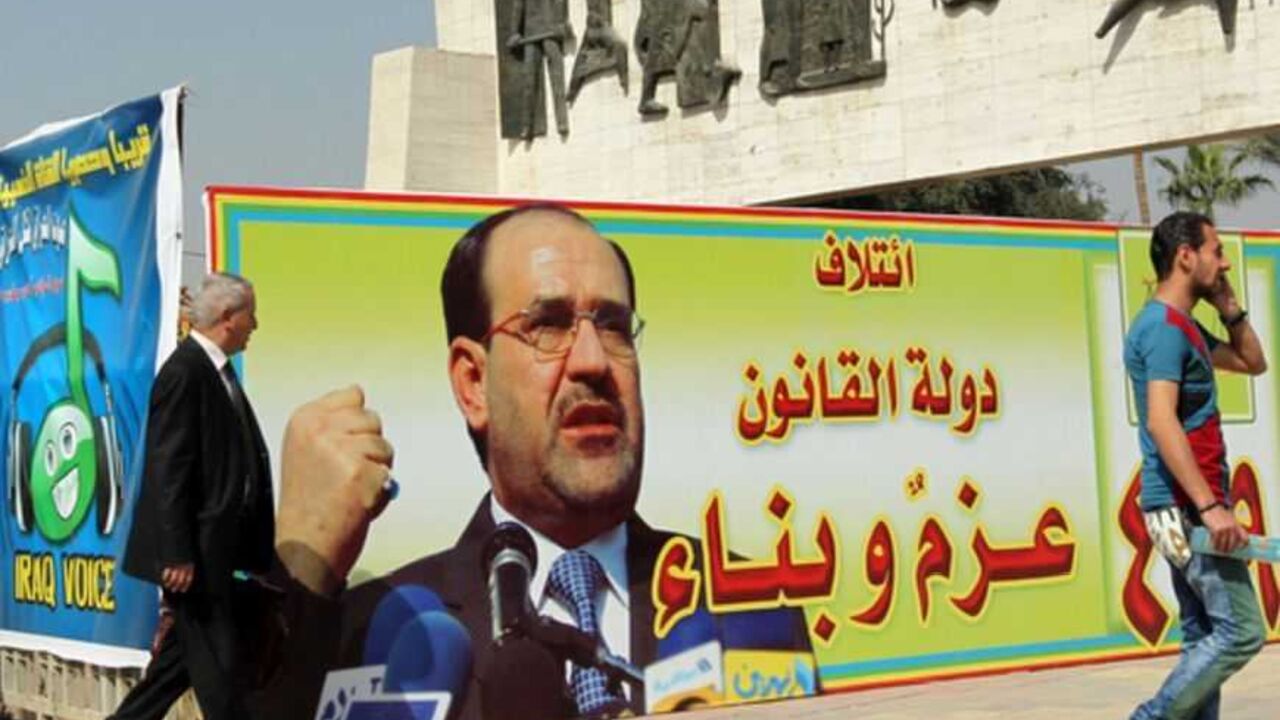 IRAQ-POLITICS-VOTE People walk past a campaign poster featuring Iraqi Prime Minister Nuri al-Maliki and announcing the provincial elections on March 2, 2013 near Tahrir Square in Baghdad. The elections will take place in April amid a political crisis in Iraq that has pitted Nuri al-Maliki against several of his erstwhile government partners and tensions have been heightened by the protests. AFP PHOTO SABAH ARAR (Photo credit should read SABAH ARAR/AFP/Getty Images)
