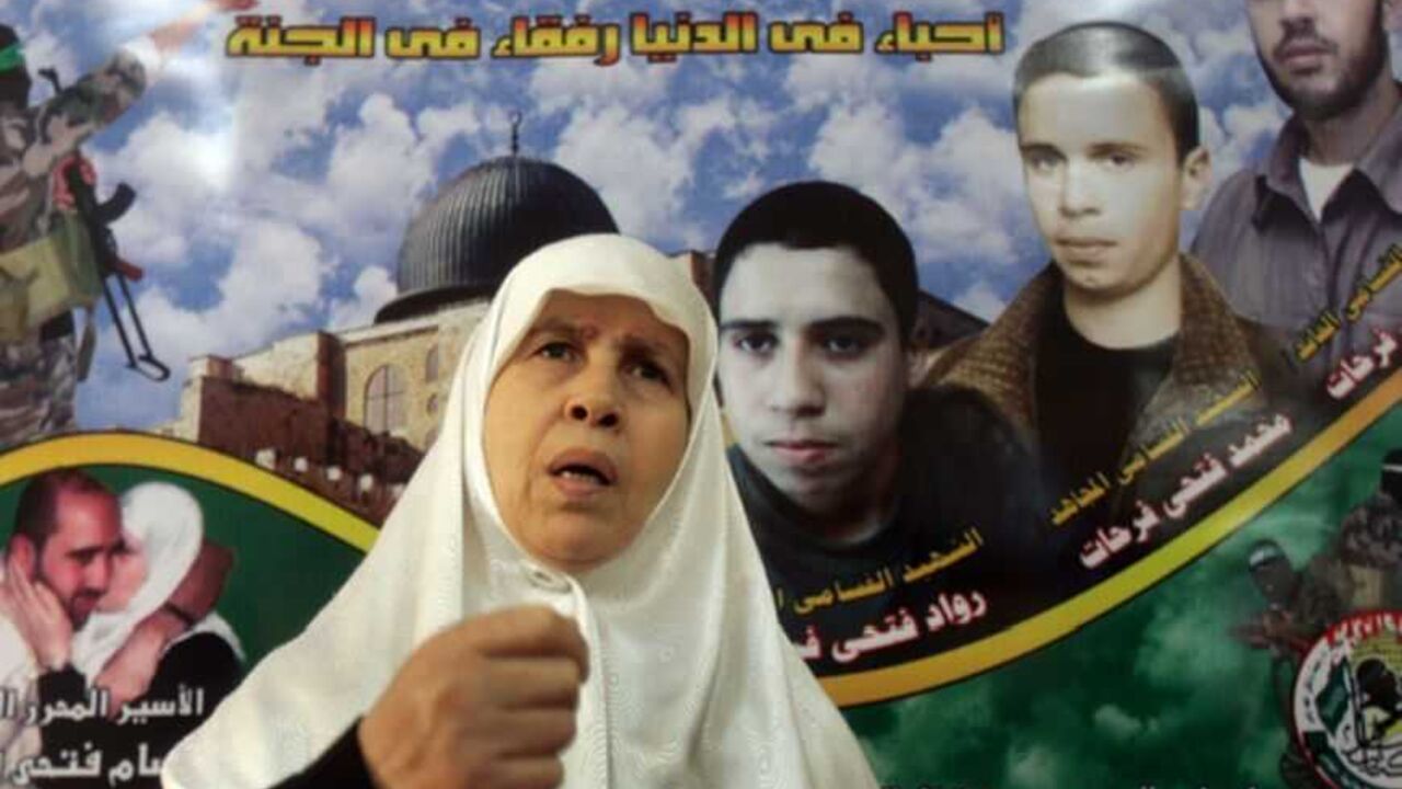Mariam Farhat a Hamas woman candidate for upcoming Palestinian parliament is seen in front of a large mural of her three dead sons inside her house in Gaza Mariam Farhat, a Hamas woman candidate for the upcoming Palestinian parliament, is seen in front of a large mural of her three dead sons inside her house in Gaza December 8, 2005. The Islamic militant group Hamas has chosen the mother of three "martyrs" who died fighting Israel to run for Palestinian parliament in a race where Hamas will likely pose a tough challenge to President Mahmoud Abbas's Fatah party. REUTERS/Suhaib Salem Pictures of the Month December 2005 - RTR1AJ4O