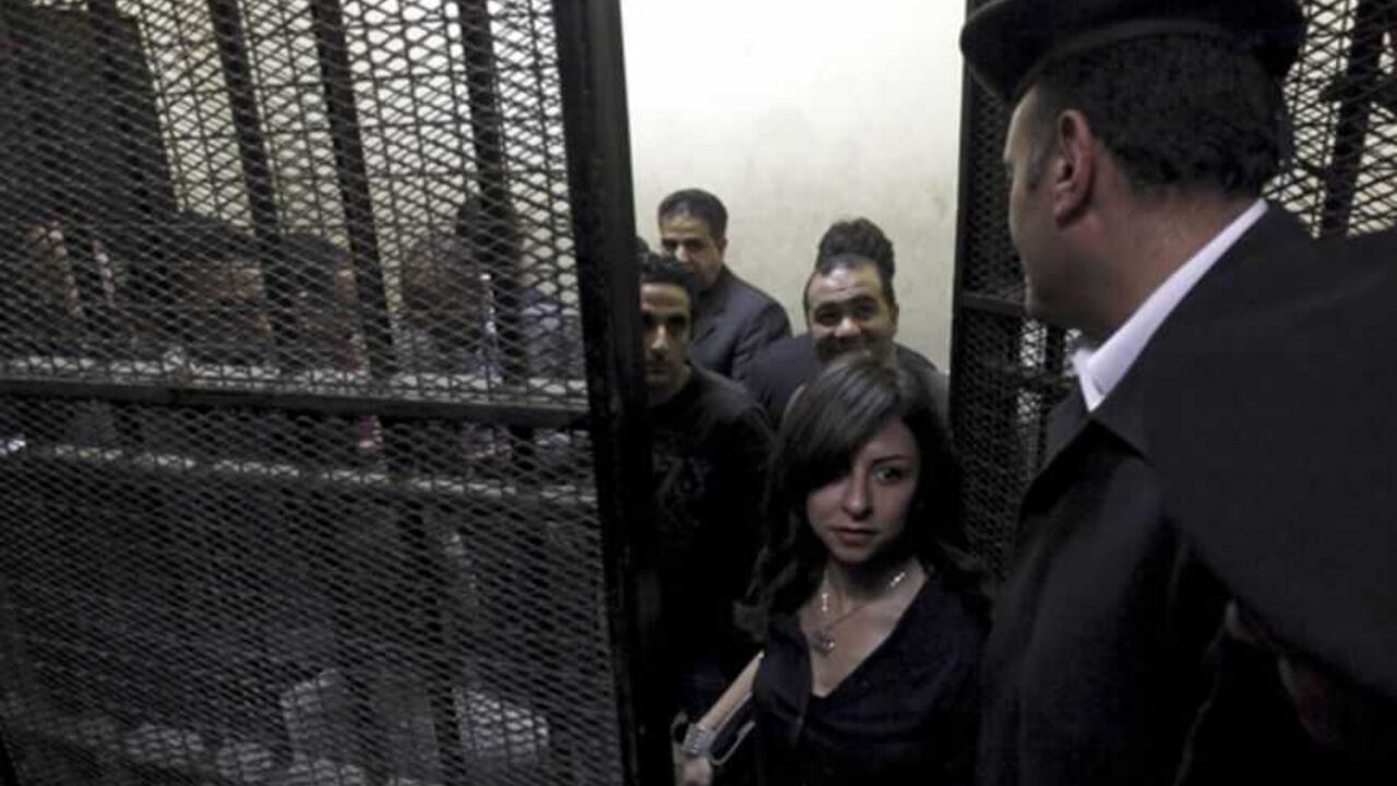 Activists, accused of working for unlicensed NGOs and receiving illegal foreign funds, stand in a cage during the opening of their trial in Cairo Activists, accused of working for unlicensed non-governmental organizations (NGOs) and receiving illegal foreign funds, stand in a cage during the opening of their trial in Cairo March 8, 2012. An Egyptian judge said on Thursday he was delaying until April 10 the trial of civil society activists including 16 Americans accused of receiving illegal foreign funds and pursuing their pro-democracy activities without a licence. REUTERS/Mohamed Abd El Ghany (EGYPT - Tags: CIVIL UNREST POLITICS CRIME LAW) - RTR2Z1