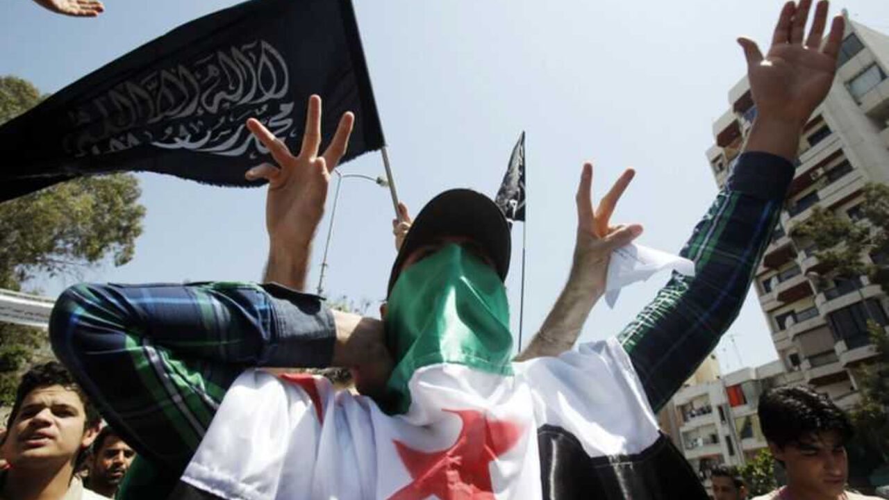 A protester covers his face with the Syrian opposition flag as he gestures and shout slogans in Beirut A protester covers his face with the Syrian opposition flag as he gestures and shout slogans, during a demonstration, organised by the Future Movement against Syria's President Bashar al-Assad, after Friday prayers in Beirut, April 27, 2012. REUTERS/Sharif Karim (LEBANON - Tags: POLITICS CIVIL UNREST) - RTR31AEX