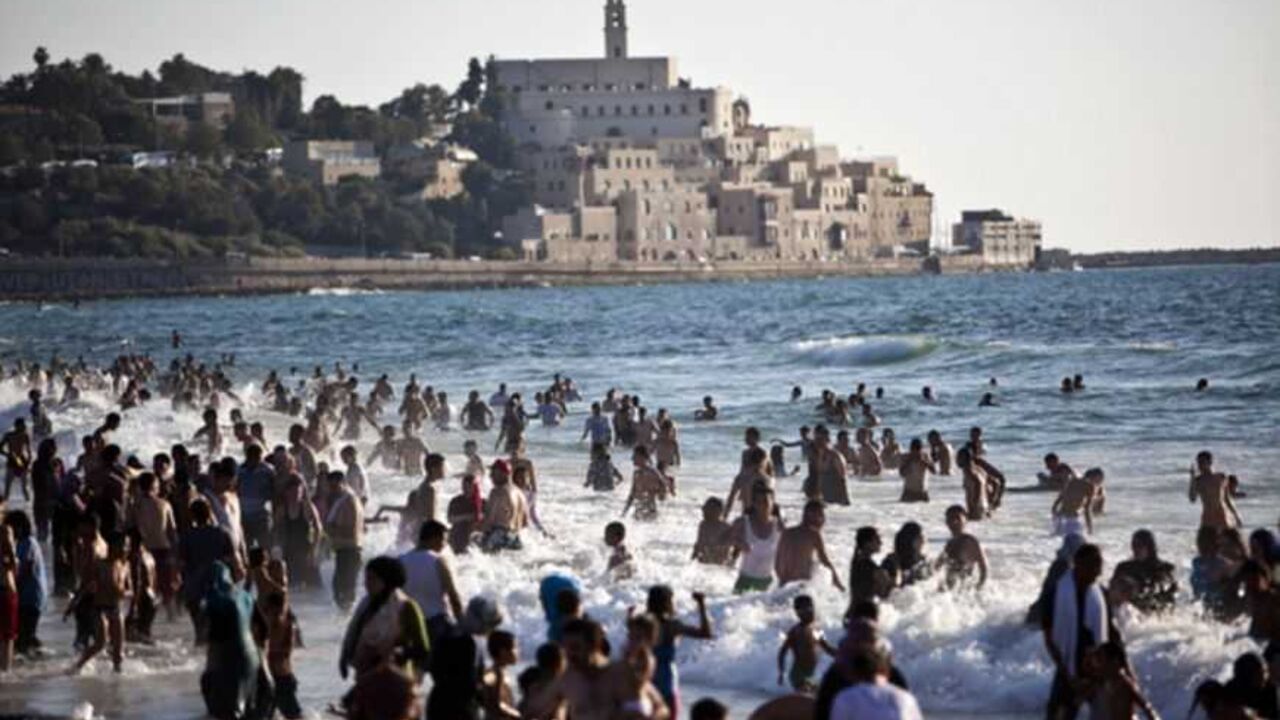 The port of Jaffa is seen in the background as Palestinians enjoy themselves at a beach in Tel Aviv during Eid al-Fitr The port of Jaffa is seen in the background as Palestinians enjoy themselves at a beach in Tel Aviv during Eid al-Fitr, which marks the end of the holy month of Ramadan August 20, 2012. A spokesperson for The Israeli Coordinator for Government Activities in the Territories' (COGAT) said that improved security had allowed for the entry of over 1 million Palestinians from the occupied West Bank since the beginning of Ramadan. REUTERS/Nir Elias (ISRAEL - Tags: RELIGION SOCIETY) - RTR36ZT5