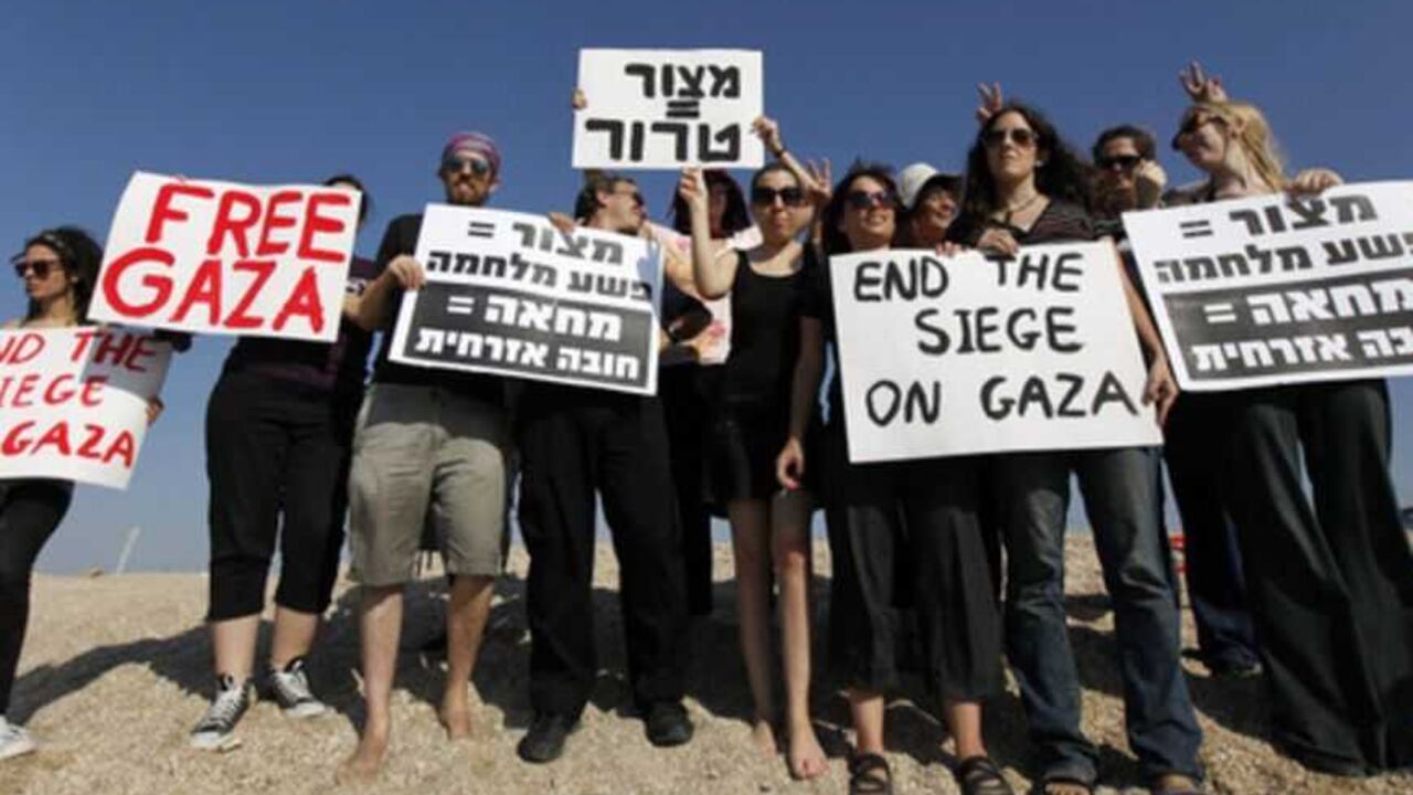 Israeli activists hold signs in support of Gaza near the entrance to the port of Ashdod Israeli activists hold signs in support of Gaza near the entrance to the port of Ashdod October 20, 2012. The Israeli navy seized an international pro-Palestinian activist ship in the Mediterranean sea on Saturday to prevent it breaching its blockade of the Gaza Strip, a military spokeswoman said. She said no one was hurt when marines boarded the SV Estelle, a three-mast schooner, and that it was rerouted to Israel's southern port of Ashdod after it ignored orders to turn away from the Hamas-governed Pales