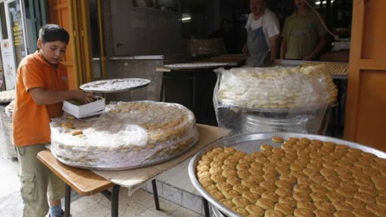 A Palestinian boy arranges traditional cookies in a box to be sold in Nablus, ahead of Eid al-Adha A Palestinian boy arranges traditional cookies in a box to be sold in the West Bank city of Nablus, ahead of Eid al-Adha, October 24, 2012. Muslims across the world are preparing to celebrate Eid al-Adha to mark the end of the haj by slaughtering sheep, goats, cows and camels to commemorate Prophet Abraham's willingness to sacrifice his son Ismail on God's command. REUTERS/Abed Omar Qusin (WEST BANK - Tags: RELIGION FOOD) - RTR39IVB
