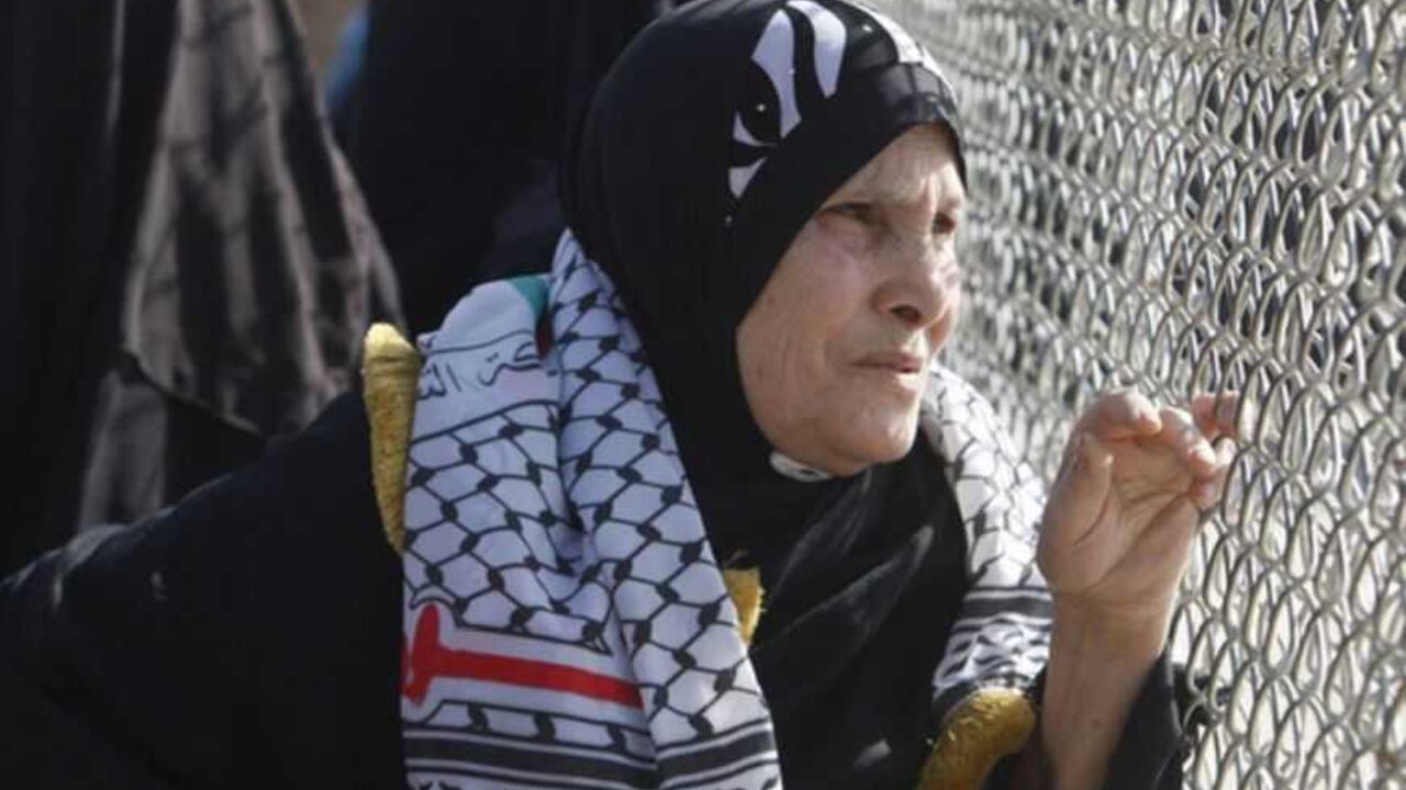 A Palestinian woman waits for the return of Fatah movement activists at the Rafah border crossing in the southern Gaza Strip A Palestinian woman waits for the return of Fatah movement activists at the Rafah border crossing in the southern Gaza Strip December 3, 2012. The Islamist Hamas group allowed the 10 activists of Palestinian President Mahmoud Abbas' Fatah movement, who fled Gaza into Egypt in 2007 during internal fighting between the two political rivals, to return home in what the group said was a sign of rapprochement, according to a Hamas official. REUTERS/Ibraheem Abu Mustafa (GAZA - Tags: POLITICS CIVIL UNREST) - RTR3
