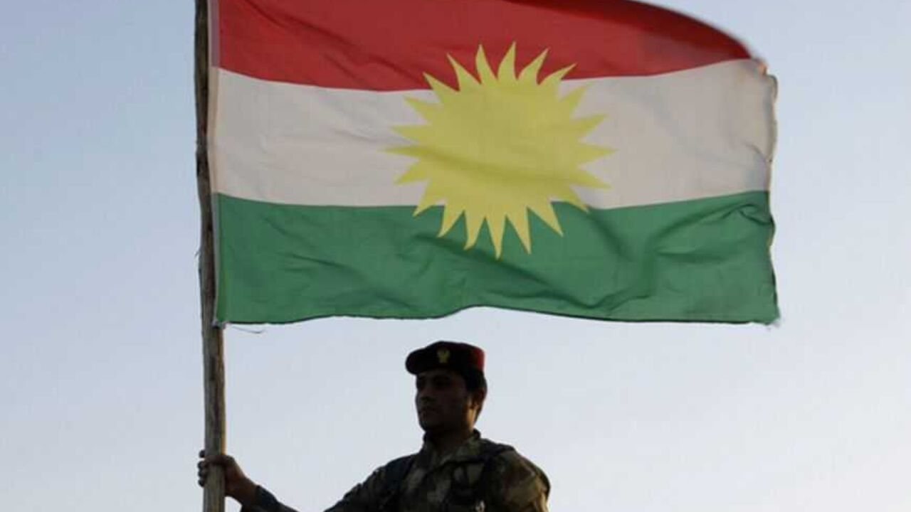 A Kurdish Peshmerga soldier holds a Kurdistan flag during a deployment in the area near the northern Iraqi border with Syria, which lies in an area disputed by Baghdad and the Kurdish region of Ninawa province A Kurdish Peshmerga soldier holds a Kurdistan flag during a deployment in the area near the northern Iraqi border with Syria, which lies in an area disputed by Baghdad and the Kurdish region of Ninawa province, August 6, 2012. Picture taken August 6, 2012. REUTERS/Azad Lashkari (IRAQ - Tags: CONFLICT POLITICS MILITARY) - RTR3B87N