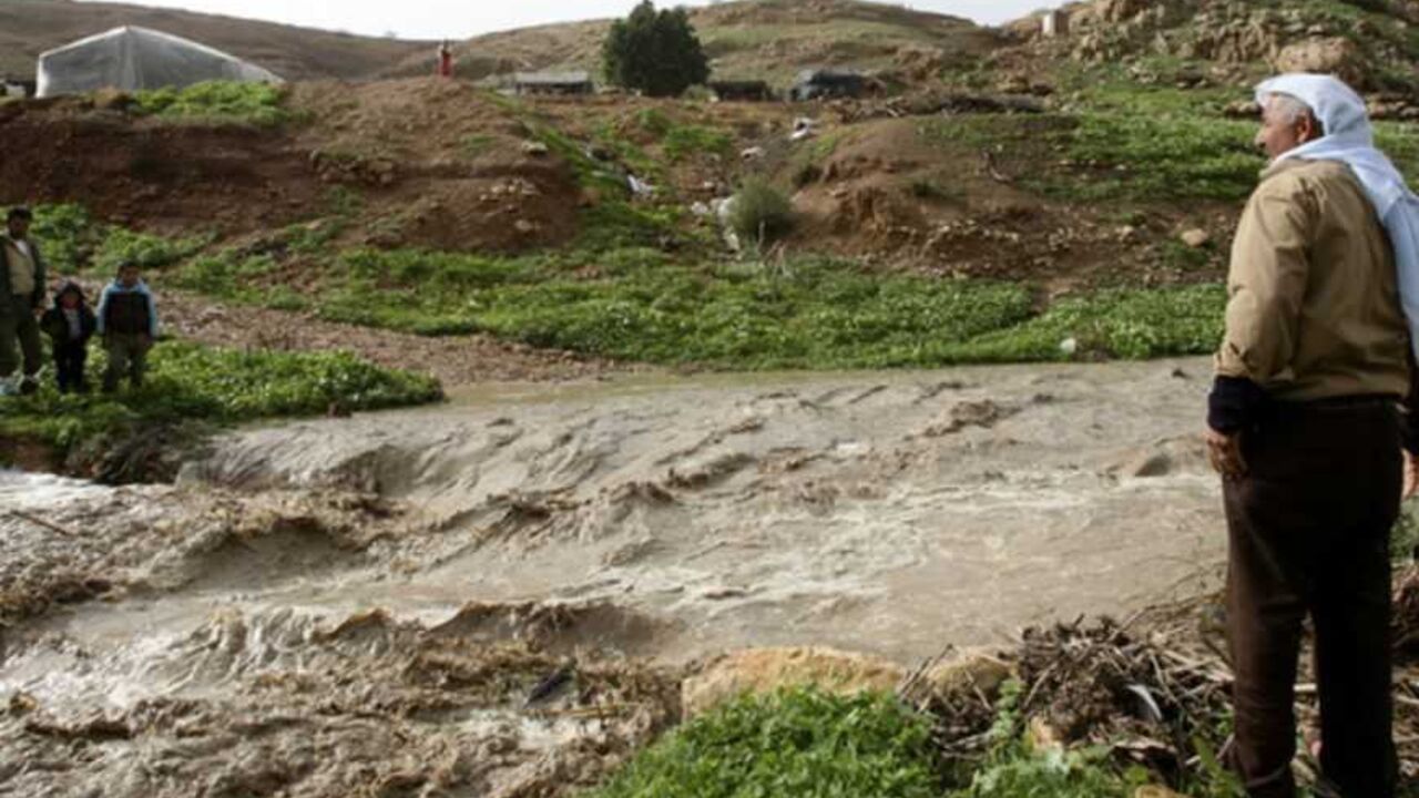 Palestinians look at water in an overflowing stream near Nablus Palestinians look at water in an overflowing stream in the West Bank village of Al-Nassariyeh near Nablus January 8, 2013. REUTERS/Abed Omar Qusini (WEST BANK - Tags: ENVIRONMENT) - RTR3C7WK
