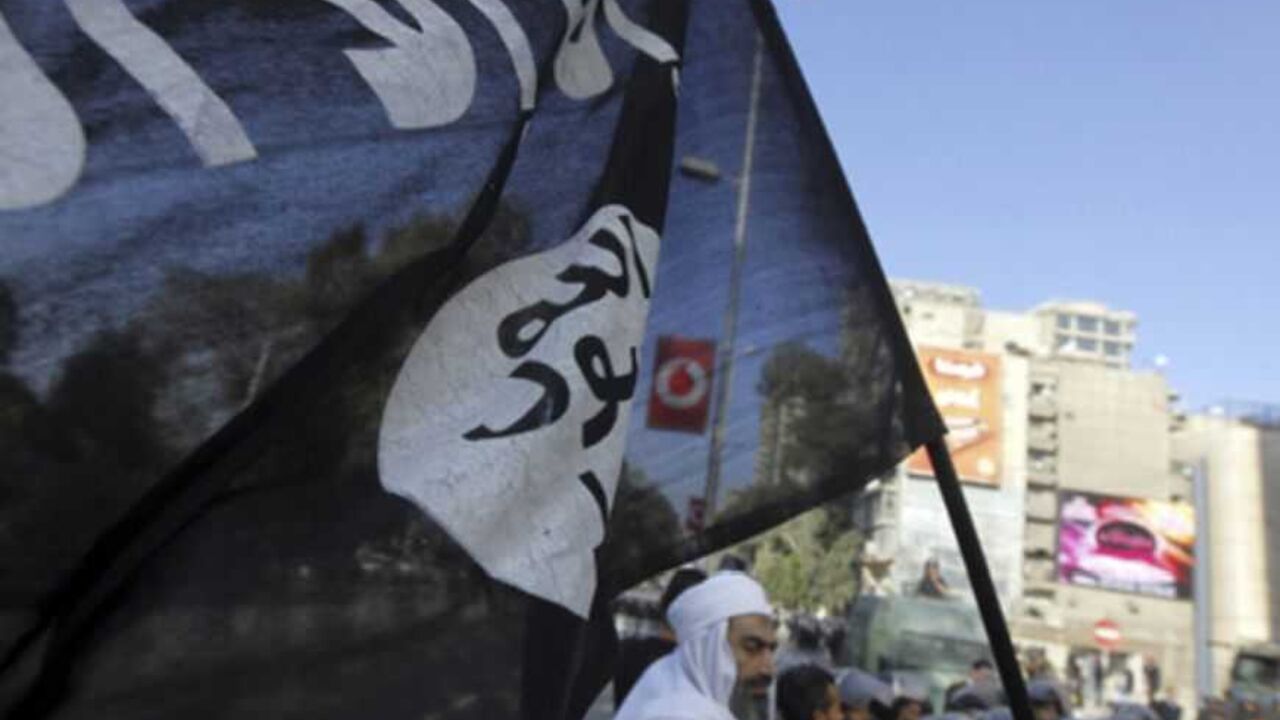 An Islamist protester holds a Salafist flag as Egyptian security forces stand guard during a protest against the French operation in Mali outside the French embassy in Cairo An Islamist protester holds a Salafist flag with Arabic words that read "There is no God but Allah and Mohammad is his prophet" as Egyptian security forces stand guard during a protest against the French operation in Mali outside the French embassy in Cairo January 18, 2013. REUTERS/Amr Abdallah Dalsh (EGYPT - Tags: POLITICS CIVIL UNREST) - RTR3CLWR