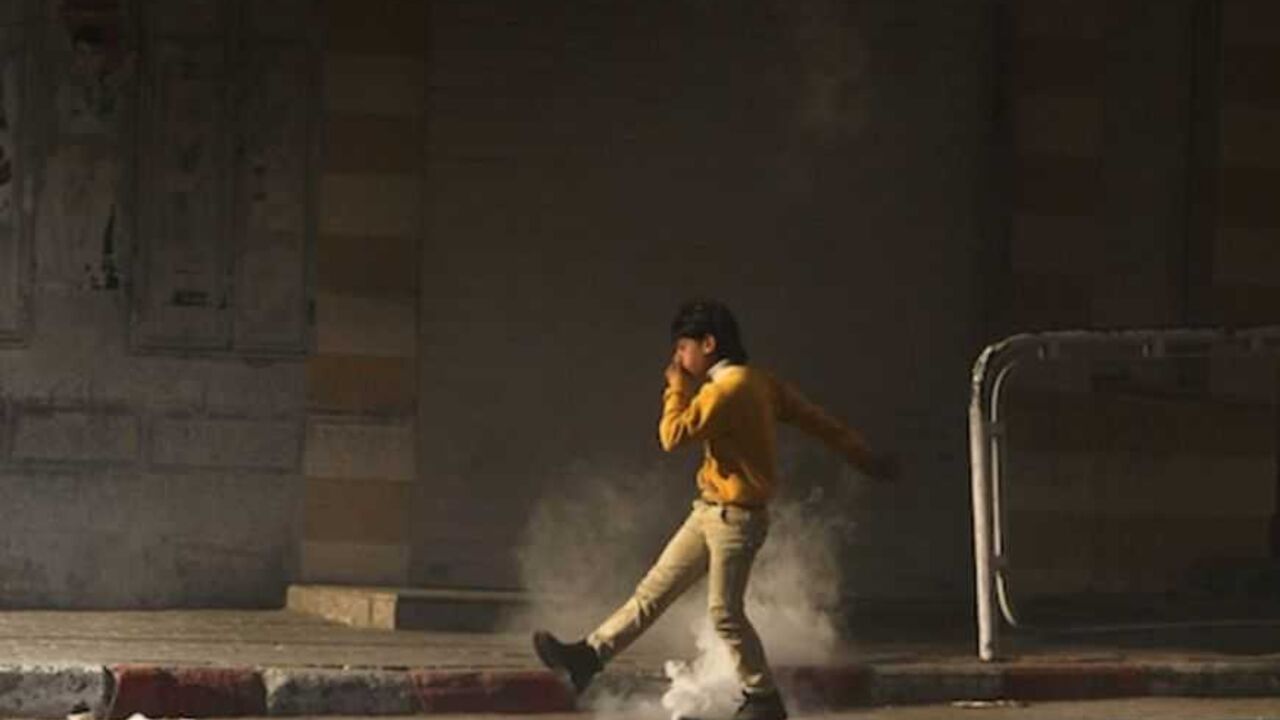 A Palestinian youth tries to kick a tear gas canister back to Israeli troops during clashes with stone-throwers in Hebron A Palestinian youth tries to kick a tear gas canister back to Israeli troops during clashes with stone-throwers that broke out after a rally in the West Bank city of Hebron to show solidarity with prisoners on hunger strike in Israeli jails February 18, 2013. Palestinians in the West Bank held demonstrations to show solidarity with prisoners on hunger strike in Israeli jails on Monday, some of which sparked clashes with Israeli forces. REUTERS/Ammar Awad (WEST BANK - Tags: POLITICS CIVIL UNREST TPX IMAGE