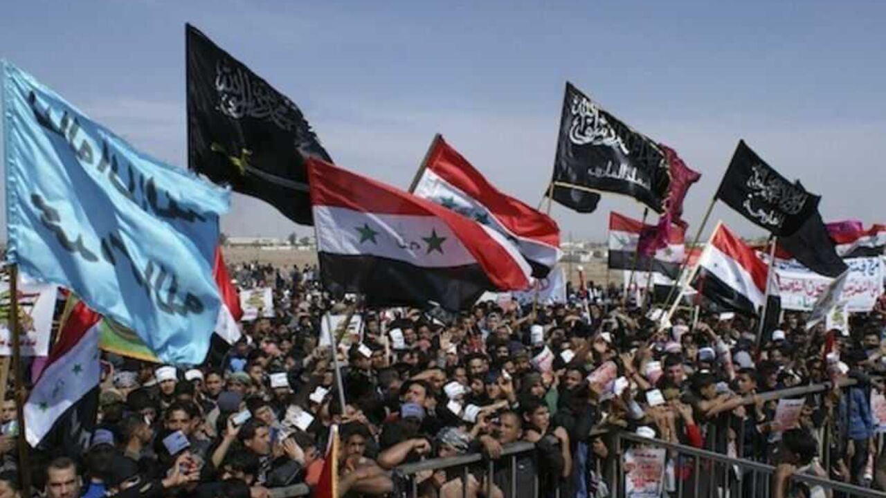 Iraqi Sunni Muslims take part in an anti-government demonstration in Falluja Iraqi Sunni Muslims take part in an anti-government demonstration in Falluja, 50 km (31 miles) west of Baghdad March 1, 2013. Iraq's finance minister told crowds of Sunni Muslim protesters on Friday he was resigning, after more than two months of demonstrations demanding an end to marginalisation of their minority sect. REUTERS/Mohanned Faisal (IRAQ - Tags: POLITICS CIVIL UNREST) - RTR3EFVK