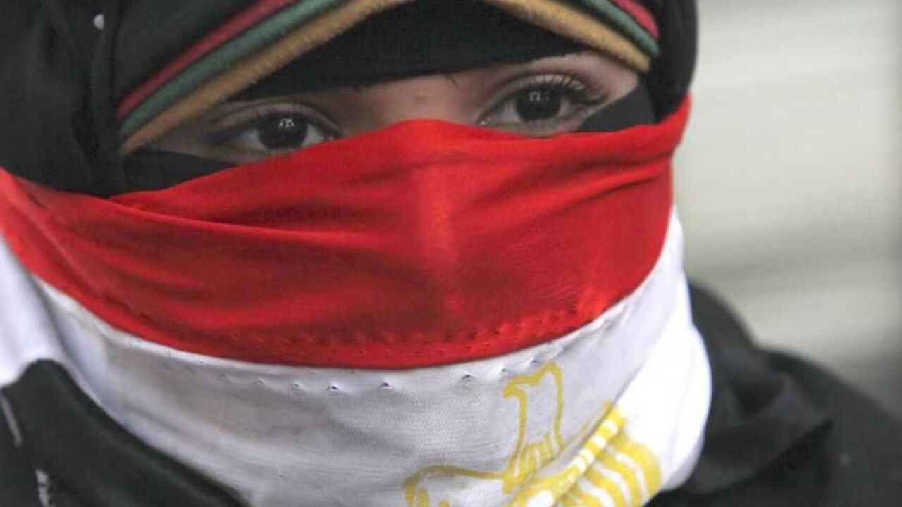 A woman takes part in a protest rally against Egyptian President Mohamed Mursi and members of the Muslim Brotherhood in Cairo A woman, with the national flag covering part of her face, takes part in a protest rally against Egyptian President Mohamed Mursi and members of the Muslim Brotherhood in front of the courthouse and the Attorney General's office, near Tahrir Square in Cairo March 8, 2013. The rally was organized by women and falls on International Women's Day. REUTERS/Amr Abdallah Dalsh (EGYPT - Tags: POLITICS CIVIL UNREST) - RTR3EQTA