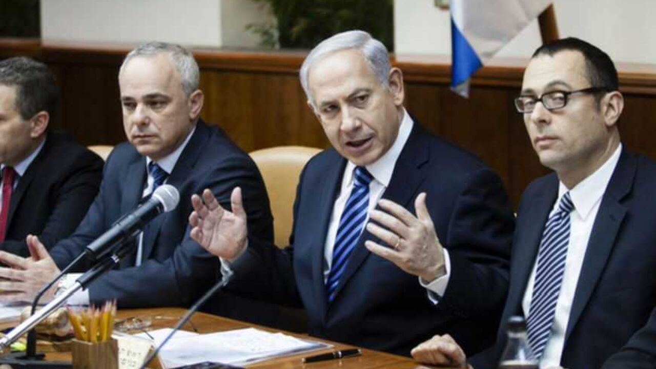 Israeli Prime Minister Netanyahu gestures as he speaks during the first cabinet meeting of the 33rd Israeli government, in Jerusalem Israeli Prime Minister Benjamin Netanyahu (C) gestures as he speaks during the first cabinet meeting of the 33rd Israeli government, in Jerusalem March 18, 2013. Netanyahu's new governing coalition took office after a parliamentary vote on Monday with powerful roles reserved for supporters of settlers in occupied territory. REUTERS/David Vaaknin/Pool (JERUSALEM - Tags: POLITICS) - RTR3F5ZH