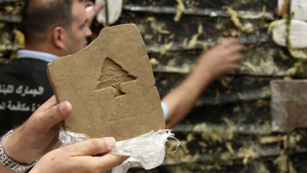 Lebanese customs employee displays a packet of confiscated hashish stamped with a Lebanese cedar in Beirut A Lebanese customs employee displays a packet of confiscated hashish stamped with a Lebanese cedar in Beirut May 27, 2009. Lebanese Internal Security forces and Lebanese Customs anti-drugs trafficking division seized a total of 85 kg (187 lbs) of hashish hidden in a refrigerated container that was supposed to be smuggled into the Netherlands. REUTERS/Mohamed Azakir (LEBANON SOCIETY CRIME LAW) - RTXOFL7