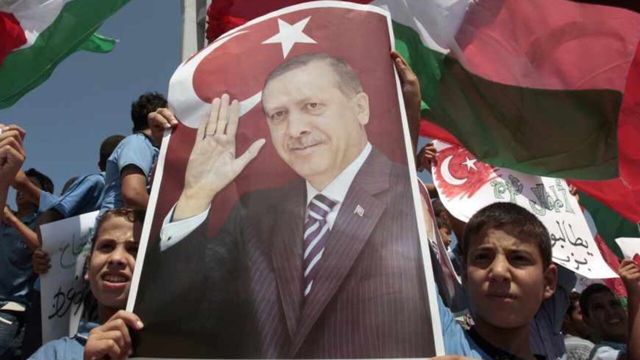 Palestinian schoolboys hold a poster depicting Turkey's Prime Minister Erdogan during a rally at Gaza Seaport Palestinian schoolboys hold a poster depicting Turkey's Prime Minister Recep Tayyip Erdogan during a rally at Gaza Seaport calling on Erdogan to visit the Gaza Strip September 13, 2011. REUTERS/Ismail Zaydah (GAZA - Tags: POLITICS EDUCATION TPX IMAGES OF THE DAY) - RTR2R8HE