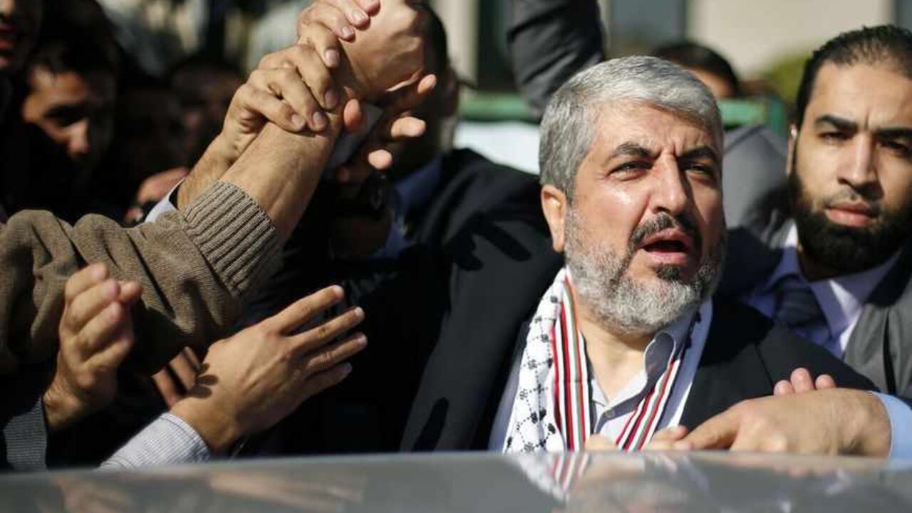 Palestinian students hold the hand of Hamas chief Meshaal during his visit to the Islamic University in Gaza Palestinian students hold the hand of Hamas chief Khaled Meshaal (2nd R) during his visit to the Islamic University in Gaza City December 9, 2012. Meshaal, in a defiant speech during his first ever visit to Gaza, told a mass rally on Saturday he would never recognise Israel and pledged to "free the land of Palestine inch by inch". REUTERS/Suhaib Salem (GAZA - Tags: POLITICS ANNIVERSARY CIVIL UNREST) - RTR3BDJP