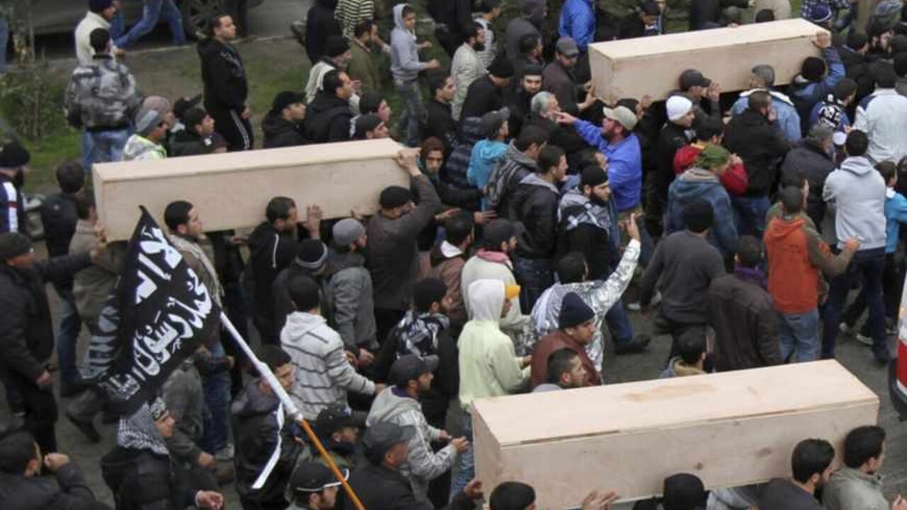 A general view of the crowd carrying coffins of Lebanese Islamist militants after their bodies arrived from Syria, in Tripoli, northern Lebanon A general view of the crowd carrying coffins of Lebanese Islamist militants after their bodies arrived from Syria, in Tripoli, northern Lebanon December 22, 2012. Funerals will be held in Lebanon for three Lebanese Islamist militants killed while fighting with rebels in Syria. REUTERS/Omar Ibrahim (LEBANON - Tags: POLITICS CIVIL UNREST) - RTR3BU8U