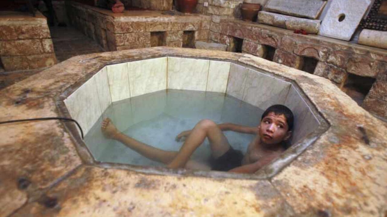 A Palestinian boy relaxes at the Hamam al-Samra, a traditional Turkish bath, in Gaza City A Palestinian boy relaxes at the Hamam al-Samra, a traditional Turkish bath, in Gaza City October 27, 2010. The Hamam al-Samra, open 24 hours daily with separate hours for men and women, is about 1,000 years old and is frequented by local Palestinians for bathing purposes as well as treatment for various ailments. REUTERS/Suhaib Salem (GAZA - Tags: SOCIETY) - RTXTVW3