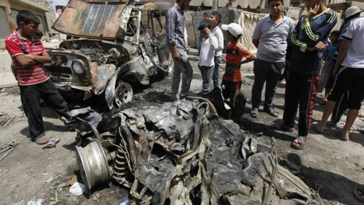 Residents gather at the site of a car bomb attack in the Kamaliya district in Baghdad Residents gather at the site of a car bomb attack in the Kamaliya district in Baghdad April 15, 2013. Car bombs and attacks on cities across Iraq, including two blasts at a checkpoint at Baghdad international airport, killed at least 20 people and wounded more than 200 on Monday, police said. The wave of attacks in Baghdad, Kirkuk, Tuz Khurmato and other towns to the north to south, came days before Iraqis vote in provincial elections that will test political stability more than a year after U.S. troops lef