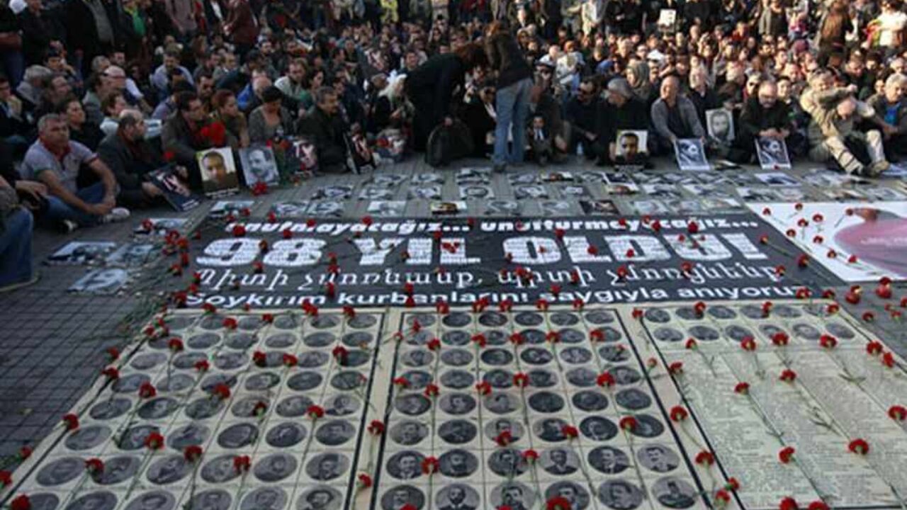 TURKEY/ Human rights activists sit behind pictures of Armenian victims at Taksim square in central Istanbul April 24, 2013, during a demonstration to commemorate the 1915 mass killing of Armenians in the Ottoman Empire. REUTERS/Osman Orsal (TURKEY - Tags: ANNIVERSARY POLITICS CIVIL UNREST) - RTXYYD8