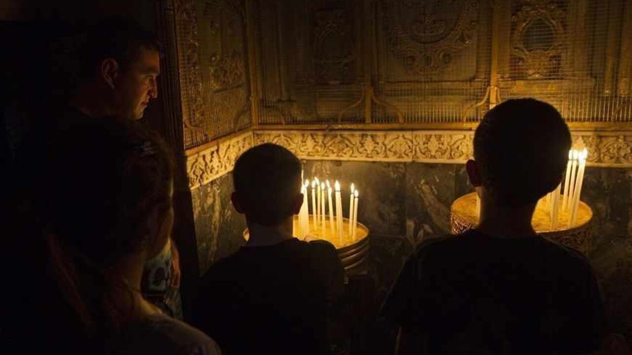 ISRAEL/ People light candles during a special prayer marking the anniversary of mass killings of Armenians in Ottoman Empire in 1915, in the Armenian Church in Jerusalem's Old City April 24, 2012. Armenia, backed by many historians and parliaments, says about 1.5 million Christian Armenians were killed in what is now eastern Turkey during World War One in a deliberate policy of genocide ordered by the Ottoman government. Successive Turkish governments and the vast majority of Turks feel the charge of genocide is an