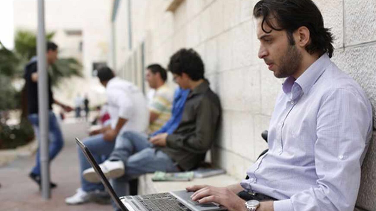 Abdullah Yaseen, a freelance web programmer, works on his laptop at al-Najah University campus in the West Bank city of Nablus April 8, 2013. Fledgling Palestinian high-tech firms hope they can now help revitalise the economy, making the West Bank more resistant to Israeli controls on land and the movement of goods and people and less dependent on fickle foreign aid flows, which are blighting the public sector. Picture taken April 8, 2013. To match Feature PALESTINIANS-HITECH/     REUTERS/Mohamad Torokman (