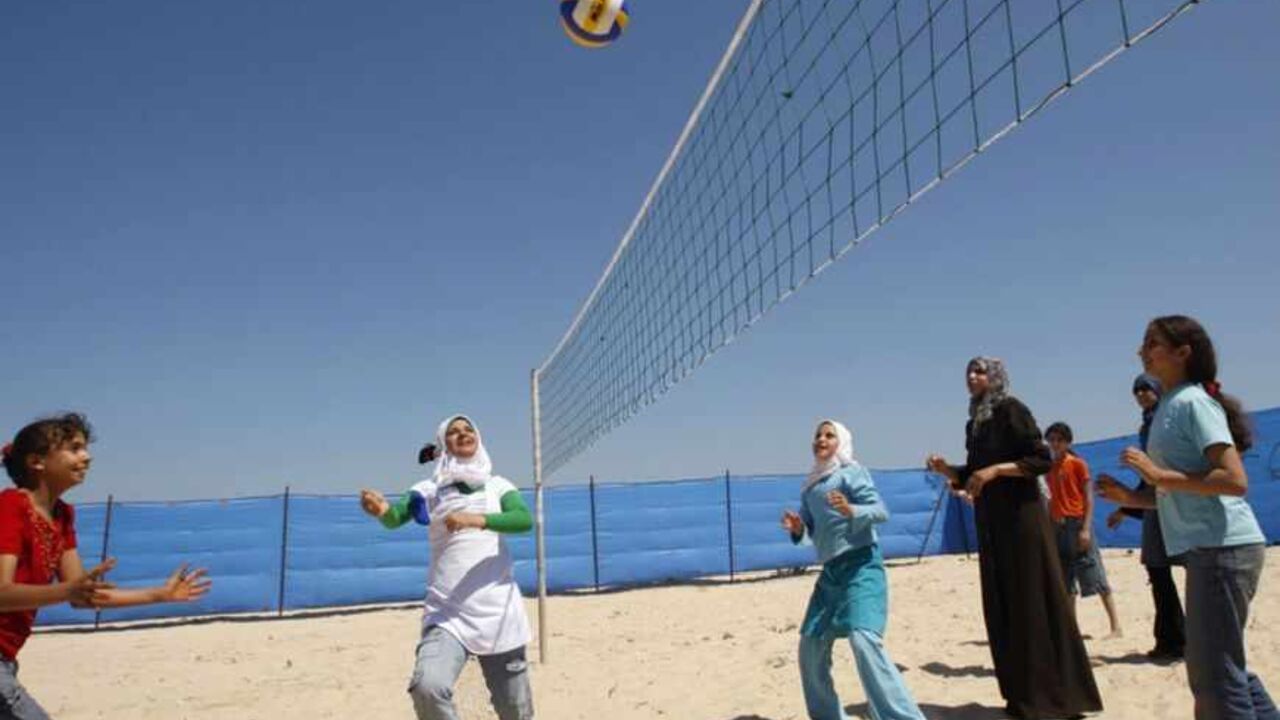 Palestinian girls play volleyball during a summer camp at the beach of Khan Younis Palestinian girls play volleyball during a summer camp at the beach of Khan Younis in the southern Gaza Strip June 20, 2009. The camp is being organized by the United Nations Relief and Works Agency (UNRWA). REUTERS/Ibraheem Abu Mustafa (GAZA CONFLICT POLITICS SPORT VOLLEYBALL) - RTR24UHL