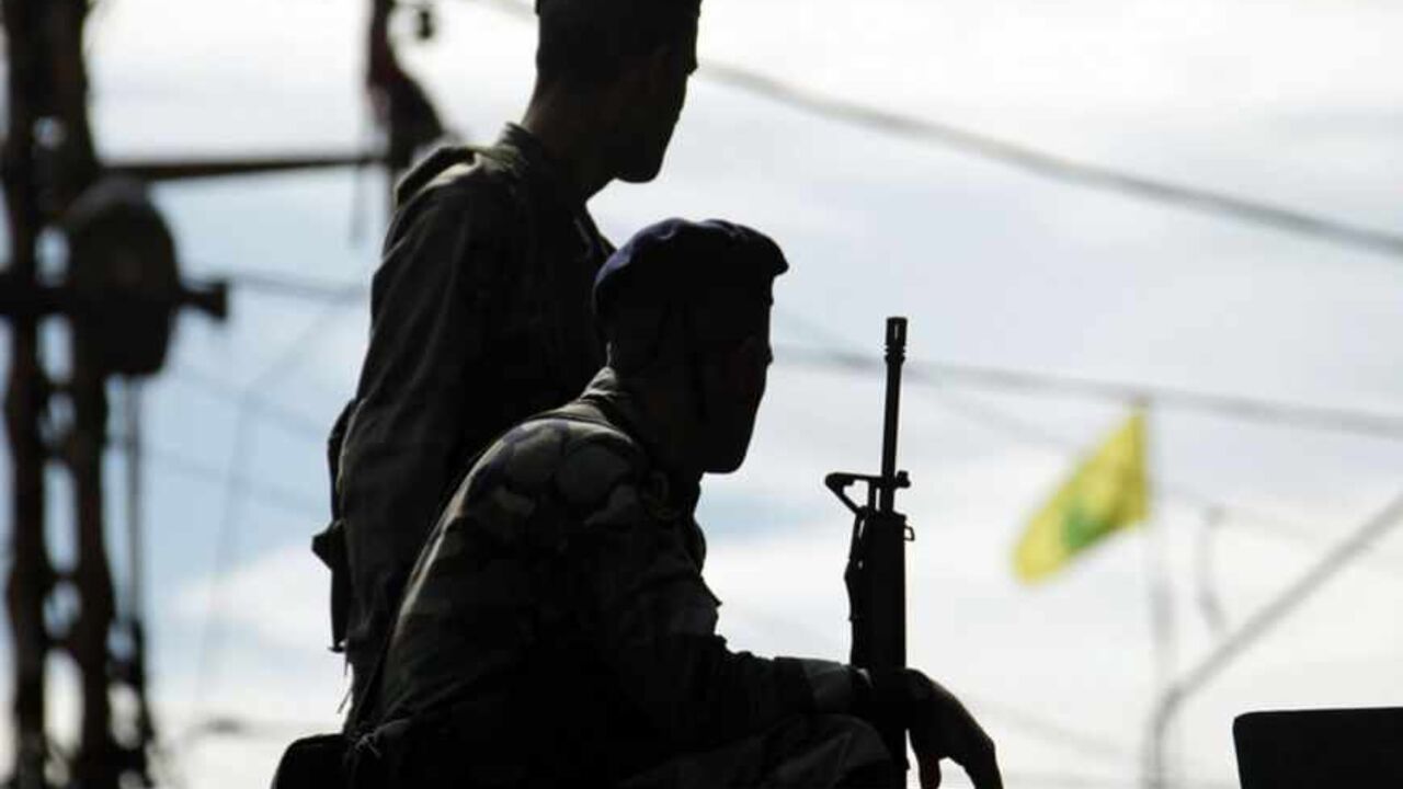 Hezbollah flag flutters in the background as Lebanese army soldiers patrol near the site where fighting broke out on Sunday in Sidon A Hezbollah flag flutters in the background as Lebanese army soldiers patrol near the site where fighting broke out on Sunday between supporters of Lebanon's Sunni Muslim Salafist leader Ahmad al-Assir and supporters of Lebanon's Hezbollah in Sidon, southern Lebanon November 12, 2012. Three people were killed on Sunday when fighting broke out in the Lebanese coastal city of Sidon between followers of the Sunni Salafist preacher and supporters of the Lebanese Shi'ite guerrilla movement Hezbollah, a security