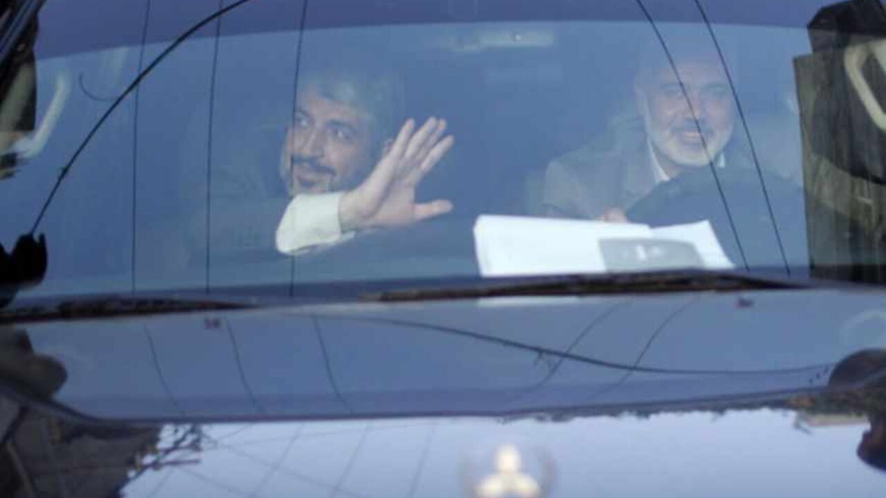 Hamas chief Meshaal waves to people in Rafah before leaving Gaza Strip Hamas chief Khaled Meshaal (L) waves to people as he sits in a jeep beside senior Hamas leader Ismail Haniyeh in Rafah before leaving Gaza Strip December 10, 2012. Hamas leader Meshaal ended his first visit to the Gaza Strip on Monday with a pledge his Islamist movement would strive to heal political rifts with Palestinian rivals who hold sway in the occupied West Bank. REUTERS/Ahmed Jadallah (GAZA - Tags: POLITICS) - RTR3BFC0