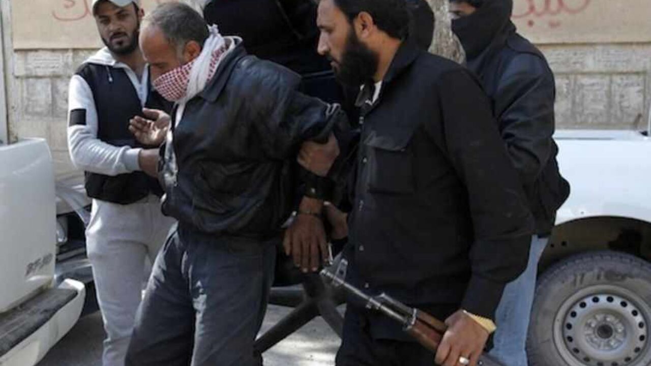 Members of Islamist Syrian rebel group Jabhat al-Nusrain hold a detainee as they transport him in Raqqa province Members of Islamist Syrian rebel group Jabhat al-Nusrain hold a detainee as they transport him in Raqqa province, eastern Syria, March 14, 2013. REUTERS/Hamid Khatib (SYRIA - Tags: CONFLICT POLITICS) - RTR3EZGD