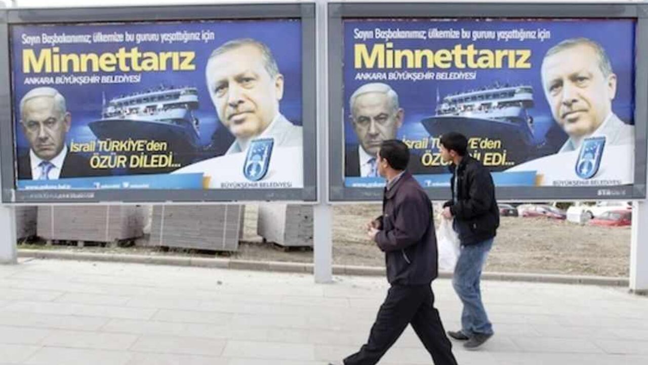 Pedestrians look at billboards with the pictures of Turkey's Prime Minister Erdogan and his Israeli counterpart Netanyahu in Ankara Pedestrians look at billboards with the pictures of Turkey's Prime Minister Tayyip Erdogan (R) and his Israeli counterpart Benjamin Netanyahu (L), in Ankara March 25, 2013. Turkey's Prime Minister Tayyip Erdogan said on Saturday an Israeli apology for the 2010 deaths of nine Turkish pro-Palestinian activists that was brokered by U.S. President Barack Obama met Turkey's conditions and signalled its growing regional clout. The billboard reads, "Israel apologized to Turkey. Dear Prime Minister (Erdogan), We ar