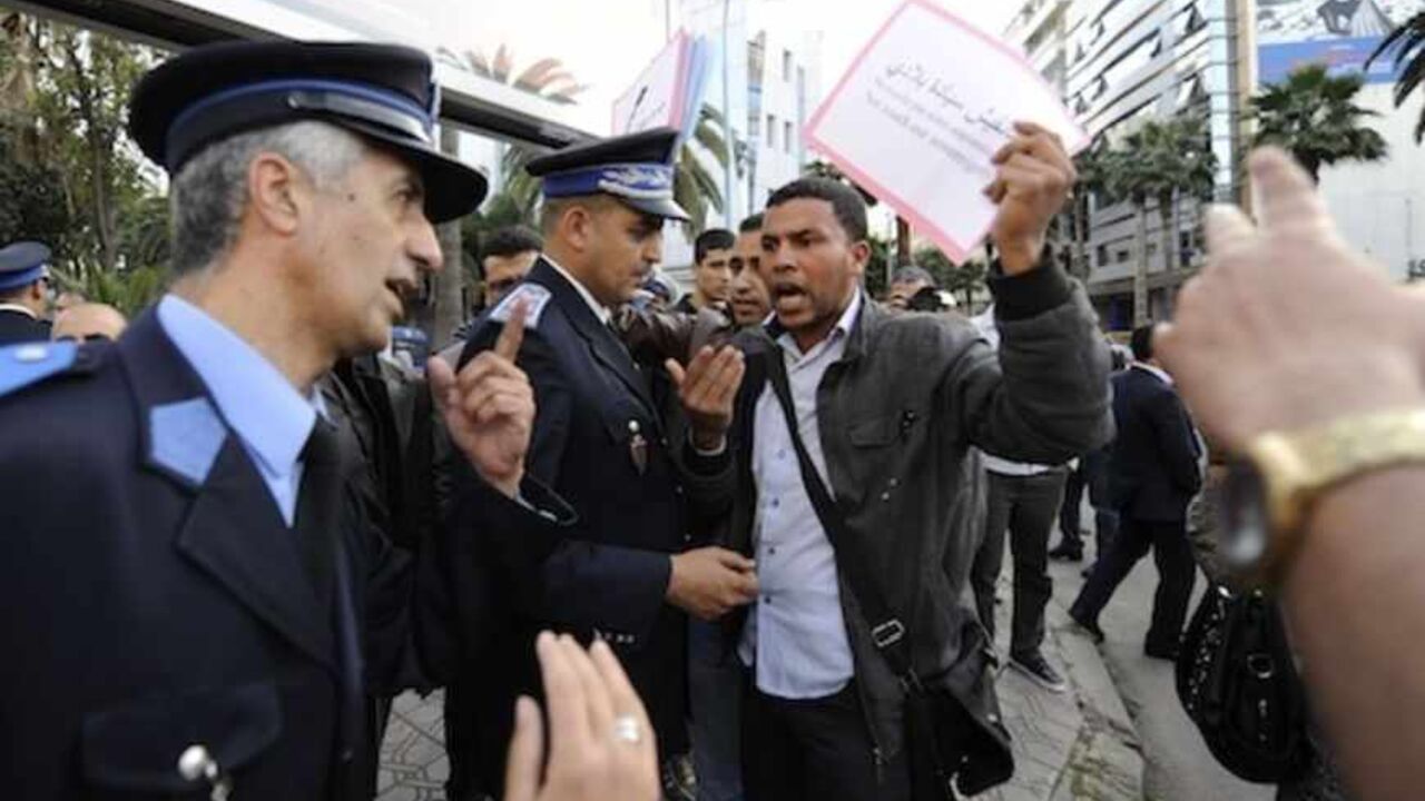 Protester argues with police officers as he protests against U.S.-backed plans to broaden mandate of UN peacekeepers in the disputed Western Sahara, in Casablanca A protester argues with police officers as he protests against U.S.-backed plans to broaden the mandate of UN peacekeepers in the disputed Western Sahara, in Casablanca April 22, 2013. REUTERS/Youssef Boudlal (MOROCCO - Tags: POLITICS CIVIL UNREST) - RTXYW4L