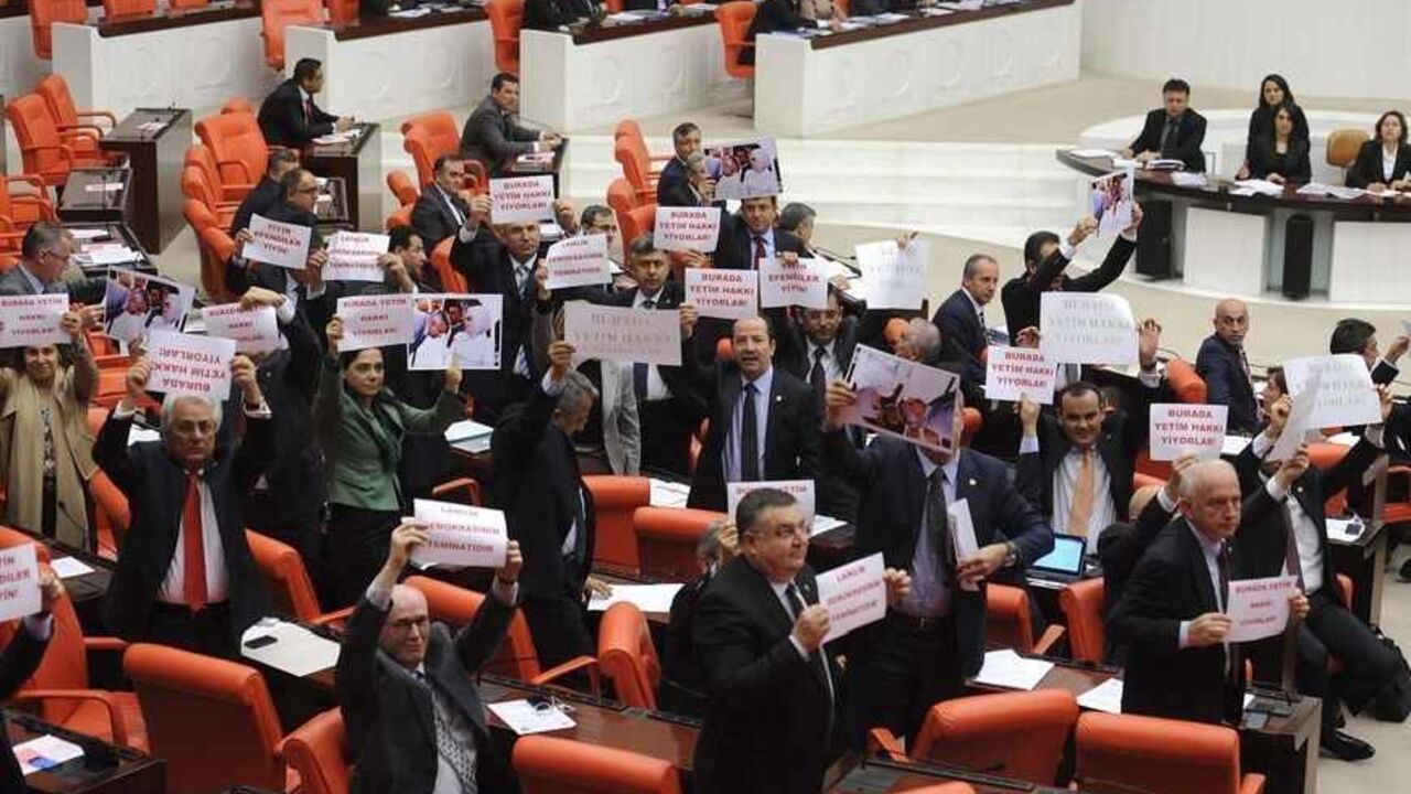 TURKEY-EDUCATION/ Members of Turkish parliament from the main opposition Republican People's Party (CHP) stage a protest during a debate at the parliament in Ankara March 30, 2012. Turkey's ruling party pushed through a school reform act on Friday that provoked brawls among parliamentarians and mass protests by secular Turks and teachers, who said the law was pushing an Islamic agenda and would lower education standards. Prime Minister Tayyip Erdogan sent shudders through the secular opposition earlier this year when he said