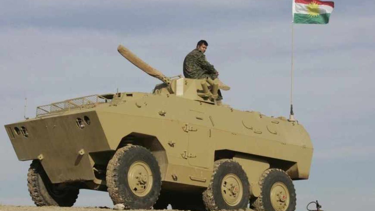 IRAQ-KURDS/ A Kurdish Peshmerga soldier sits atop an armored vehicle during a deployment of Kurdish Peshmerga troops on the outskirts of Kirkuk, some 250km (155 miles) north of Baghdad December 3, 2012. Iraq's Kurdish region has sent reinforcements to a disputed area where its troops are involved in a standoff with the Iraqi army, a senior Kurdish military official said, despite calls on both sides for dialogue to calm the situation. Picture taken December 3, 2012. REUTERS/Ako Rasheed (IRAQ - Tags: POLITICS MILITARY CI