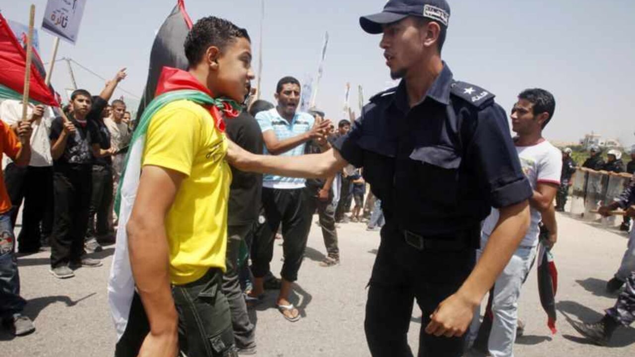 A Hamas policeman pushes back a Palestinian protester during a demonstration near Erez crossing between Israel and the Gaza Strip A Hamas policeman pushes back a Palestinian protester during a demonstration near the Erez border crossing between Israel and northern Gaza Strip June 5, 2011, marking the 44th anniversary of the start of a 1967 Middle East War, in which Israel captured East Jerusalem, the Gaza Strip, the West Bank and Golan Heights. REUTERS/Suhaib Salem (GAZA - Tags: POLITICS CIVIL UNREST ANNIVERSARY) - RTR2NB6A