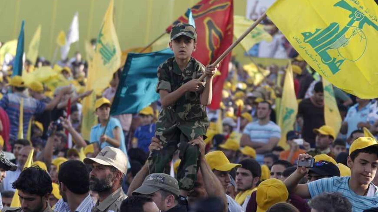 A boy wearing an army suit is held by people as they watch Lebanon's Hezbollah leader Sayyed Hassan Nasrallah as he appears on a screen during a live broadcast to speak to his supporters at an event marking Resistance and Liberation Day, in Bekaa valley A boy wearing an army suit is held by people as they watch Lebanon's Hezbollah leader Sayyed Hassan Nasrallah as he appears on a screen during a live broadcast to speak to his supporters at an event marking Resistance and Liberation Day, in Bekaa valley May 25, 2013. The event is to commemorate the 13th anniversary of Israel's withdrawal from southern Lebanon. REUTERS/Sharif Karim (LEBANON - Tags: POLITICS) MEDIA ANNIVERSARY) - RTX100EC