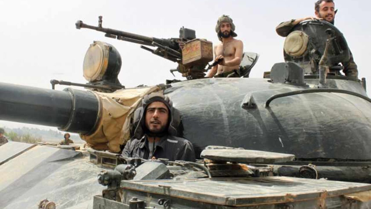 Forces of Syrian President Bashar al-Assad are seen in Arjoun village near Qusair town May 30, 2013. Syrian rebels under siege near the Lebanese border pleaded for help on Thursday against government troops and their Hezbollah allies as a confident Assad spoke of having new Russian missiles.             REUTERS/ Rami Bleible     (SYRIA - Tags: CONFLICT MILITARY) - RTX106EZ