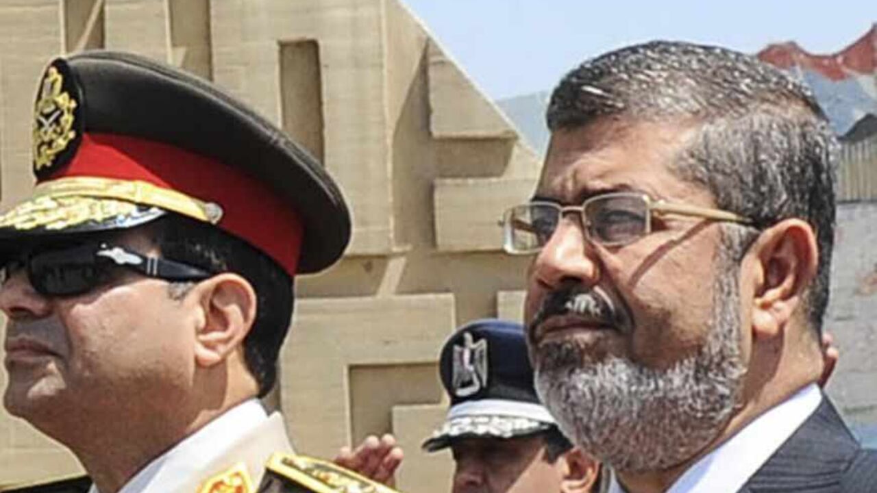 Egypt's President Mursi visits the tomb of ex-President al-Sadat and the Tomb of the Unknown Soldier during the commemoration of Sinai Liberation Day in Cairo Egypt's President Mohamed Mursi (C) stands after laying a wreath during his visit to the tomb of former President Anwar al-Sadat and the Tomb of the Unknown Soldier during the commemoration of Sinai Liberation Day in Cairo April 24, 2013. Saluting next to Mursi are Egypt's Defence Minister Abdel Fattah al-Sisi (L) and General Sedki Sobhi (R), chief of staff to Egypt's Supreme Council of the Armed Forces (SCAF). Sinai Liberation Day is marked annually on April 25. REUTERS/Egyptian Presidency/Handout (EGYPT