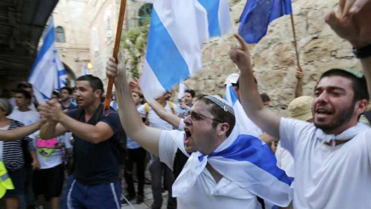 Israelis carry flags as they celebrate in Jerusalem's Old City during a parade marking Jerusalem Day Israelis carry flags as they celebrate in Jerusalem's Old City during a parade marking Jerusalem Day May 8, 2013. Jerusalem Day marks the anniversary of Israel's capture of the Eastern part of the city during the 1967 Middle East War. In 1980, Israel's parliament passed a law declaring united Jerusalem as the national capital, a move never recognised internationally. REUTERS/Ronen Zvulun (JERUSALEM - Tags: POLITICS ANNIVERSARY) - RTXZF8V