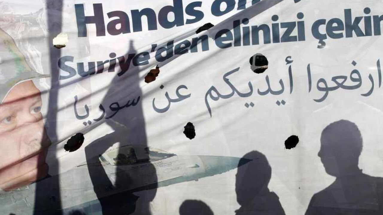 Shadows of protesters are cast on a banner as they march during a demonstration against the Turkish government's foreign policy on Syria, in central Hatay Shadows of protesters are cast on a banner as they march during a demonstration against the Turkish government's foreign policy on Syria, in central Hatay May 12, 2013. Turkey accused a group loyal to Syrian President Bashar al-Assad on Sunday of carrying out car bombings that killed 46 people in a Turkish border town and said the risk of unrest spreading to Syria's neighbours was increasing. Syrian Information Minister Omran Zubi denied any Syrian involvement and rejected what he called "unfounded accusati