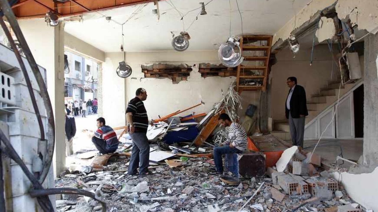 The owner of a shop and his family members wait in his damaged shop at the site of a twin bomb blast in the town of Reyhanli in Hatay province, near the Turkish-Syrian border The owner of a shop and his family members wait in his damaged shop at the site of a twin bomb blast in the town of Reyhanli in Hatay province, near the Turkish-Syrian border May 14, 2013. REUTERS/Umit Bektas (TURKEY - Tags: POLITICS CIVIL UNREST) - RTXZLWK