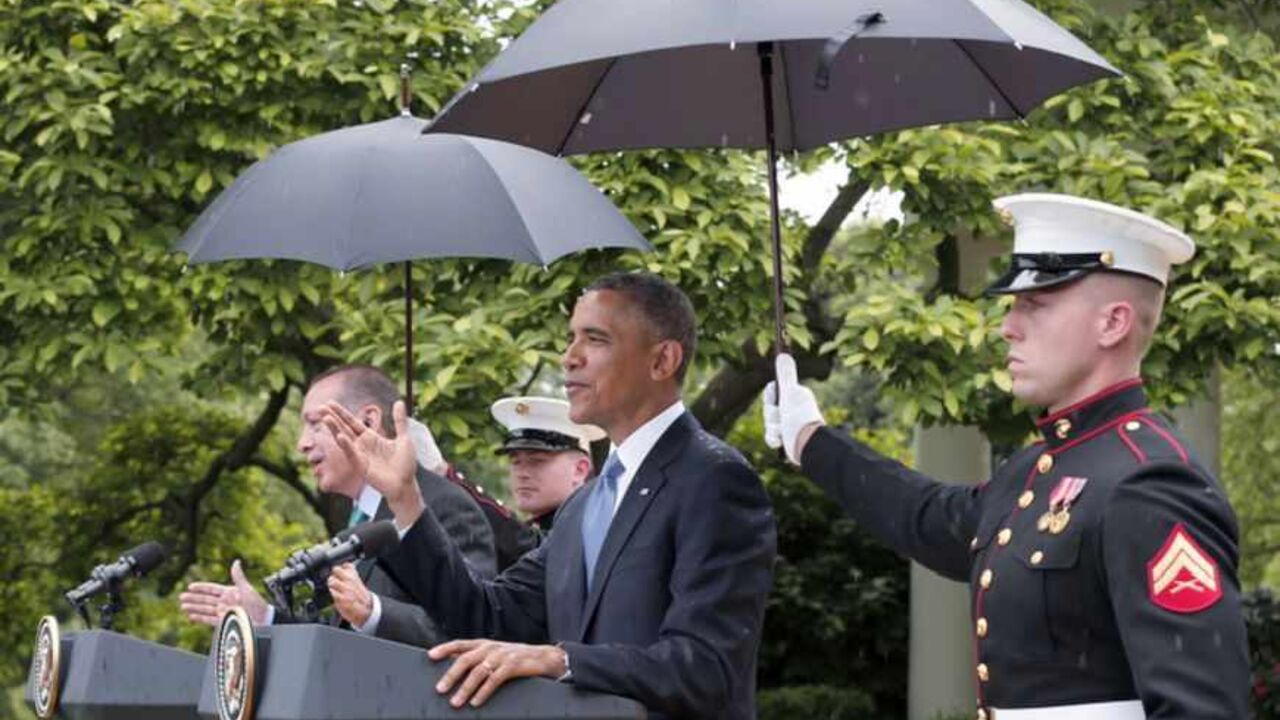 U.S. Marines hold umbrellas for U.S. President Obama and Turkish Prime Minister Erdogan during joint news conference in falling rain at the White House in Washington U.S. Marines hold umbrellas as rain falls during a joint news conference between U.S. President Barack Obama (2ndR) and Turkish Prime Minister Recep Tayyip Erdogan (L) in the White House Rose Garden in Washington, May 16, 2013. REUTERS/Kevin Lamarque (UNITED STATES - Tags: POLITICS) - RTXZPG3