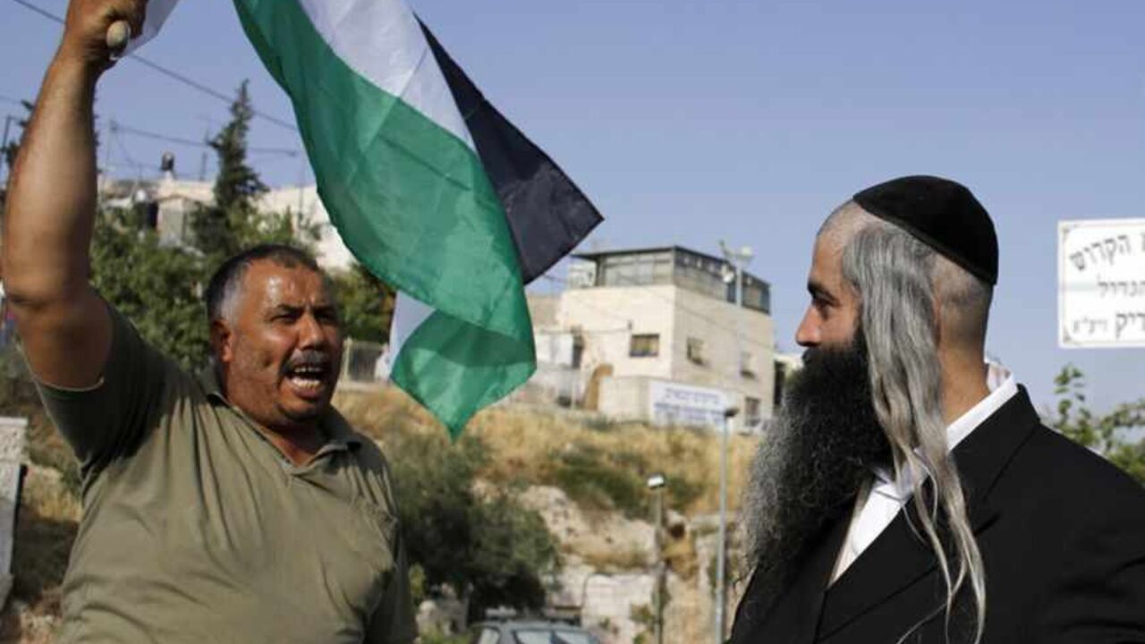 protester waving a Palestinian flag shouts at an Orthodox Jewish man in the Sheikh Jarrah neighborhood of East Jerusalem during a weekly demonstration against Jewish settlements A protester waving a Palestinian flag shouts at an Orthodox Jewish man in the Sheikh Jarrah neighborhood of East Jerusalem May 17, 2013, during a weekly demonstration against Jewish settlements and the possible eviction of a Palestinian family from their home. REUTERS/Ammar Awad (JERUSALEM - Tags: POLITICS CIVIL UNREST) - RTXZQQB
