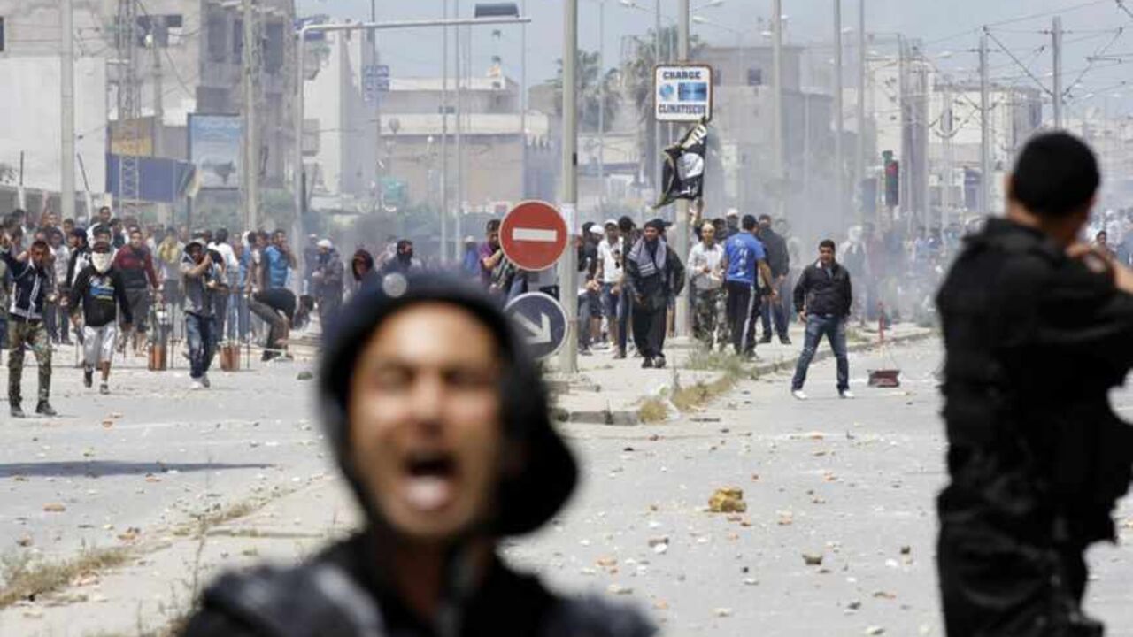 Supporters of Islamist group Ansar al-Sharia clash with riot police at Hai al Tadamon in Tunis Supporters of Islamist group Ansar al-Sharia clash with riot police at Hai al Tadamon in Tunis May 19, 2013. Supporters of the hardline Islamist group clashed with Tunisian police in two cities on Sunday after the government banned its annual rally and the regional arm of al Qaeda urged it to stand firm against the authorities. REUTERS/Anis Mili (TUNISIA - Tags: CIVIL UNREST POLITICS RELIGION) - RTXZSQP