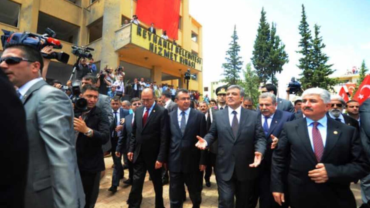 TURKEY-SYRIA-CONFLICT-BLAST-BOMBING Turkish President Abdullah Gul waves as he visits the bomb scene on May 16, 2013 during the funerals of the victims of a car bomb which went off on May 11 at Reyhanli in Hatay just a few kilometres from the main border crossing into Syria. The death toll in twin car bombings in a Turkish town near the Syrian border has increased to 50 after another body was recovered and a victim died in hospital, the health minister was quoted as saying on May 14. The attacks also provoked a backlash against Syrian refugee
