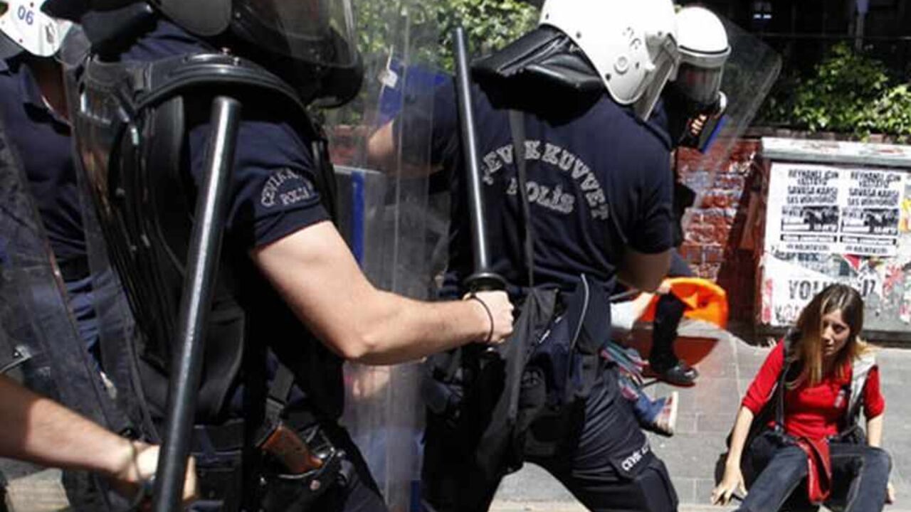 SYRIA-CRISIS/TURKEY-ZONE Riot police surround a protester during a protest against Turkey's Prime Minister Tayyip Erdogan and his government's policy on Syria, in Ankara May 18, 2013. Erdogan said on Friday it would be up to the U.N. Security Council to decide whether to establish a no-fly zone inside Syria and said he backed the involvement of Russia and China in planned peace talks. REUTERS/Umit Bektas (TURKEY - Tags: POLITICS CIVIL UNREST) - RTXZROX