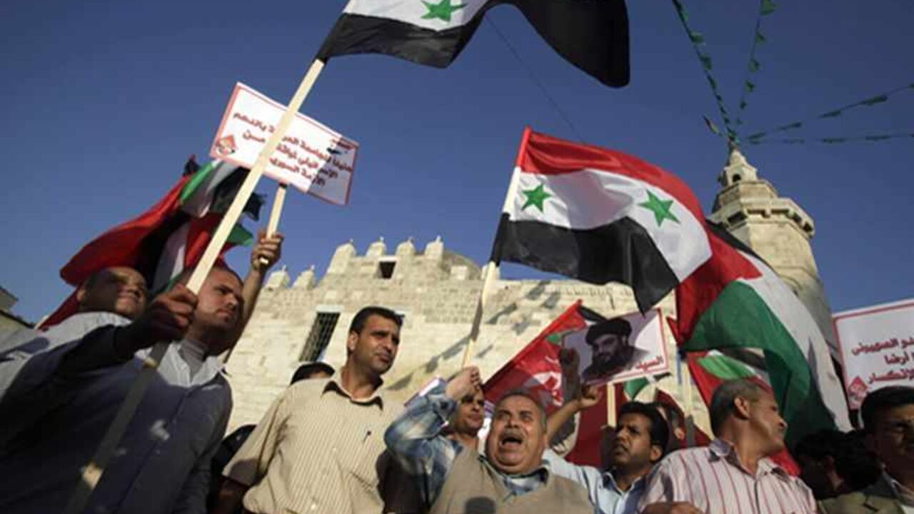 PALESTINIANS-SYRIA/ Palestinian supporters of leftist parties take part in a protest against Israeli air strikes close to Damascus, in Khan Younis in the southern Gaza Strip May 7, 2013. Israel played down weekend air strikes close to Damascus reported to have killed dozens of Syrian soldiers, saying they were not aimed at influencing its neighbour's civil war but only at stopping Iranian missiles reaching Lebanese Hezbollah militants. REUTERS/Ibraheem Abu Mustafa (GAZA - Tags: POLITICS CIVIL UNREST) - RTXZDWI