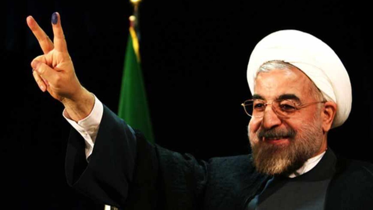 Nic6214209 Iran's former top nuclear negotiator Hassan Rowhani flashes a victory sign after registering his candidacy for the upcoming presidential election at the interior ministry in Tehran on May 7, 2013. Iran began a five-day registration period for candidates in Iran's June 14 presidential election, with a string of conservative hopefuls in the running but with key reformists yet to come forward, media reports said. AFP PHOTO/BEHROUZ MEHRI (Photo credit should read BEHROUZ MEHRI/AFP/Getty Images)